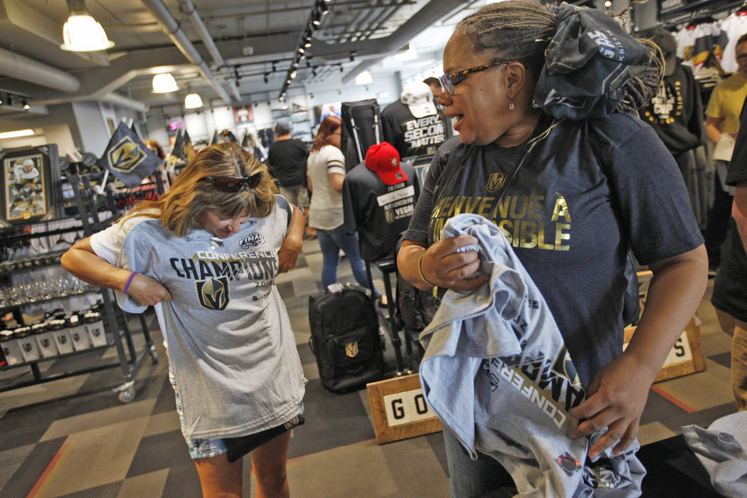 Beverly Marques holds up her Golden Knights western conference championship shirt as Kamala Frazho looks on at the Arsenal retail store at the City National Arena in Las Vegas, Sunday, May 20, 201 ...