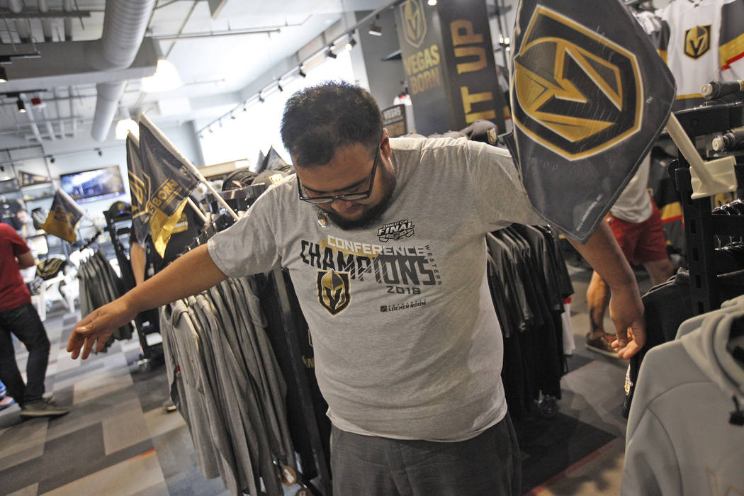Faustino Solis tries on his Golden Knights western conference championship shirt at the Arsenal retail store at the City National Arena in Las Vegas, Sunday, May 20, 2018. The shirts, all 150 of t ...