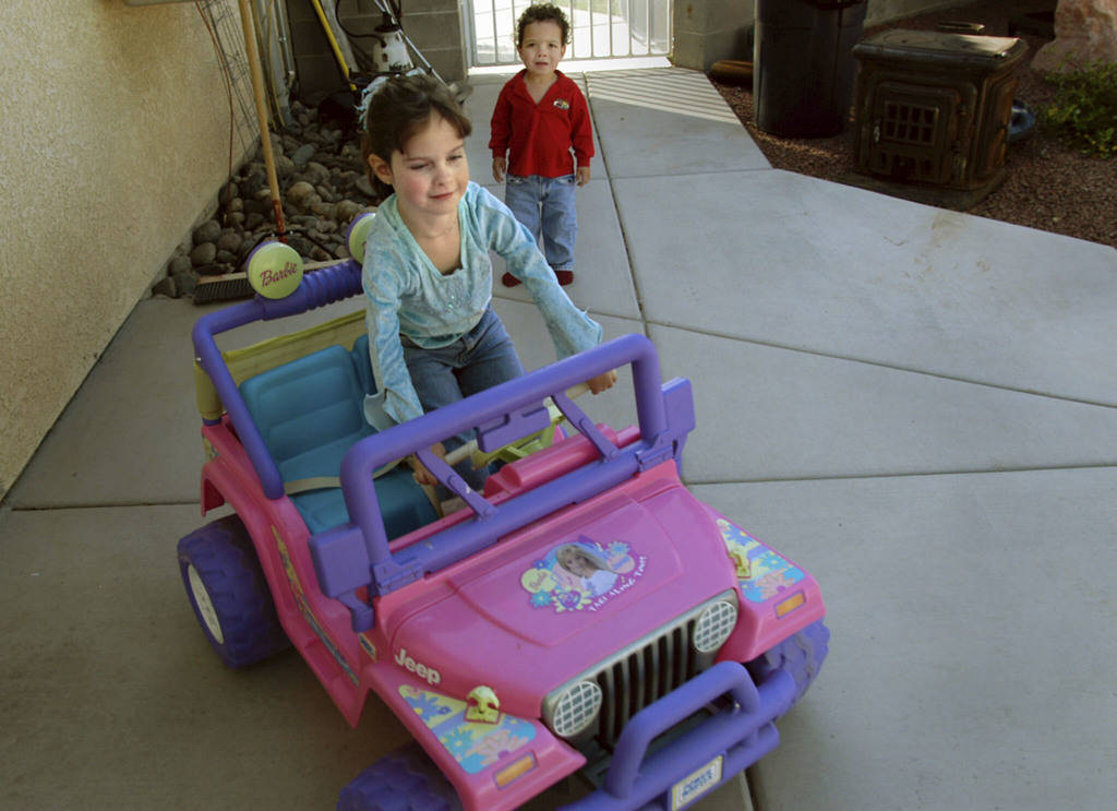 CN/VIEW--Seven year old Jessica Lindley drives her Jeep as her 2 year old brother, Carson watches in their Las Vegas backyard, Thursday, 4_19_07. Jessica has taken 22 flights on Miracle Flight for ...