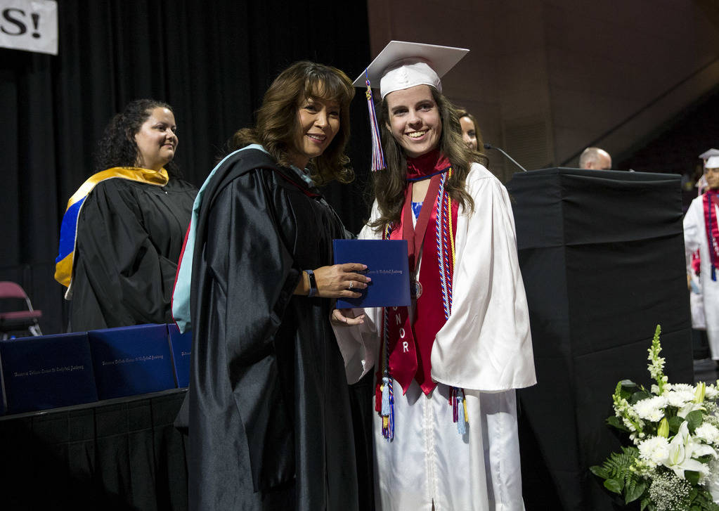 Veterans Tribute Career & Technical Academy Principal Tammy Boffelli, left, presents Jessica Lindley with her diploma during the schools commencement ceremony at the Orleans Arena in Las Vegas ...