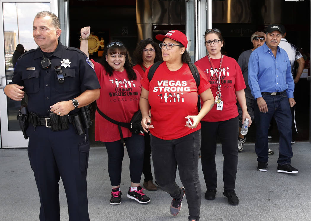 Culinary and bartender union workers, including, Martha Rojas, second left, and Adela Montez, center, leave the Thomas & Mack Center in Las Vegas on Tuesday, May 22, 2018, after voting whether the ...