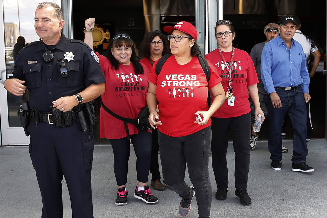 Culinary and bartender union workers, including, Mratha Rojas, second left, and Adela Montez, center, leave, Thomas and Mack Center in Las Vegas on Tuesday, May 22, 2018 after voting whether they ...