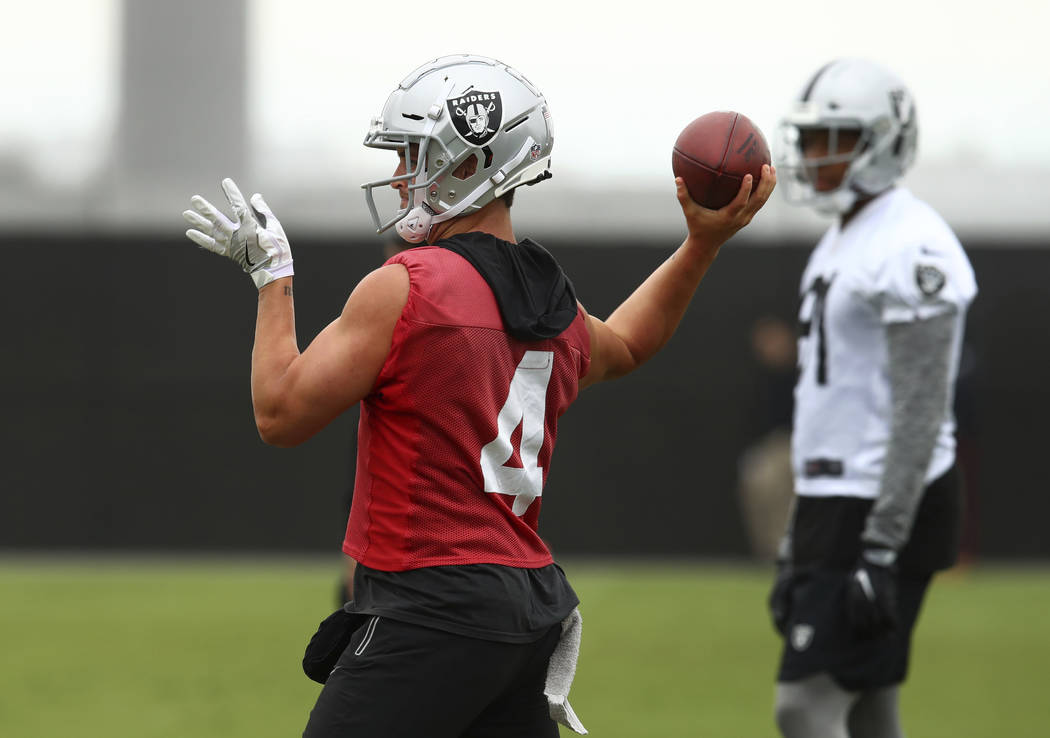 Oakland Raiders quarterback Derek Carr passes during NFL football practice on Tuesday, May 22, 2018, at the team's training facility in Alameda, Calif. (AP Photo/Ben Margot)