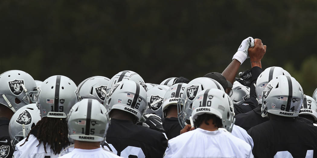 Oakland Raiders huddle during NFL football practice on Tuesday, May 22, 2018, at the team's training facility in Alameda, Calif. (AP Photo/Ben Margot)