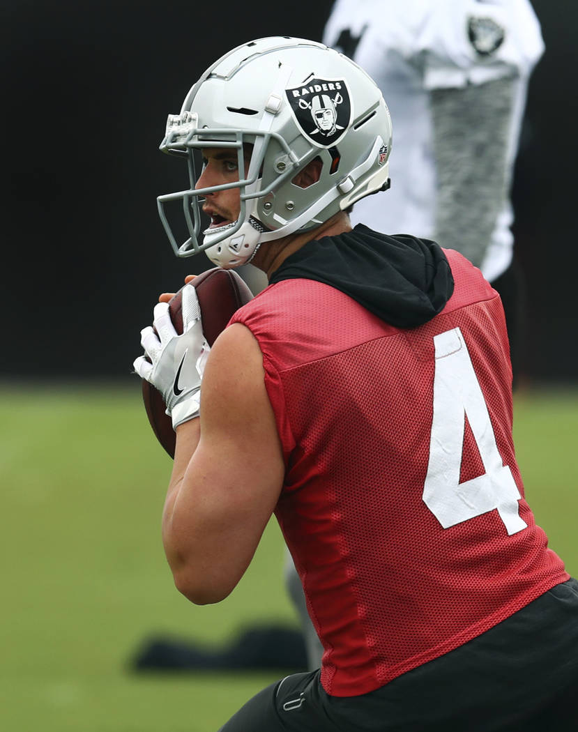 Oakland Raiders quarterback Derek Carr looks to pass during NFL football practice on Tuesday, May 22, 2018, at the team's training facility in Alameda, Calif. (AP Photo/Ben Margot)