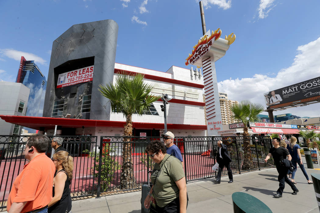 People walk on the Strip near Harmon Avenue past a 16-acre piece of property that is for sale Tuesday, May 22, 2018. K.M. Cannon Las Vegas Review-Journal @KMCannonPhoto
