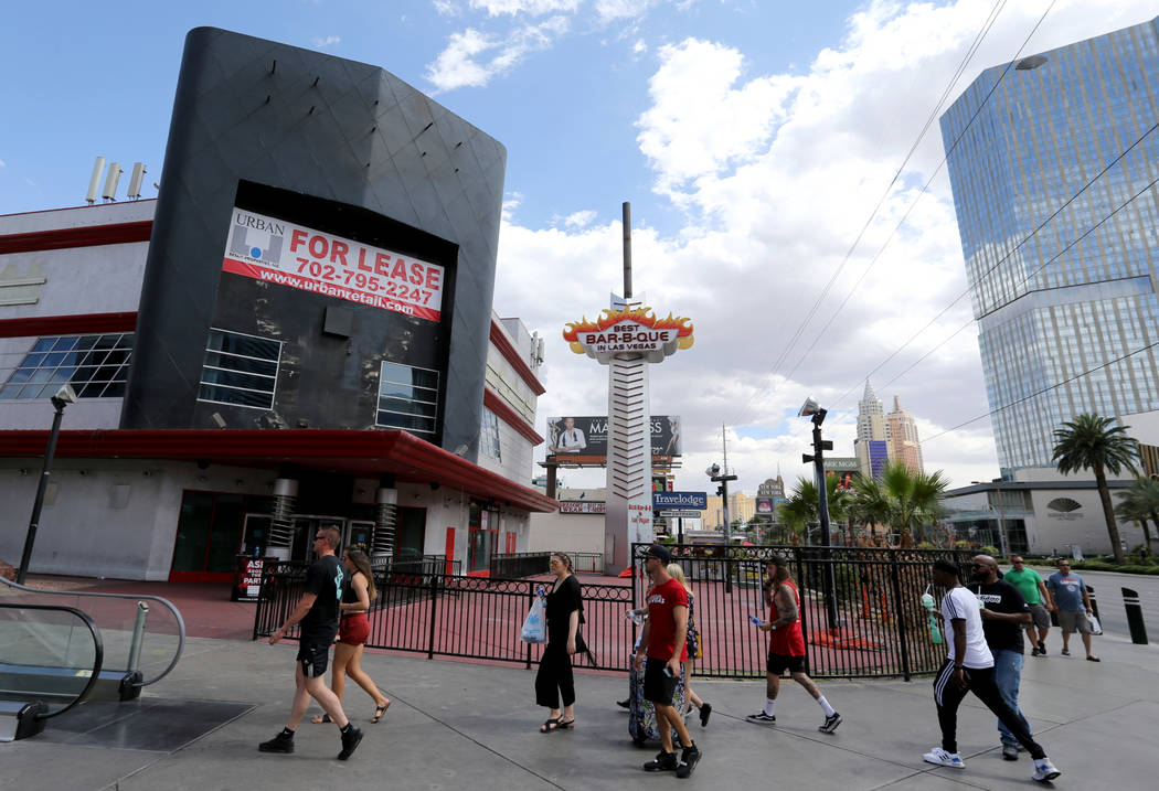 People walk on the Strip near Harmon Avenue past a 16-acre piece of property that is for sale Tuesday, May 22, 2018. K.M. Cannon Las Vegas Review-Journal @KMCannonPhoto