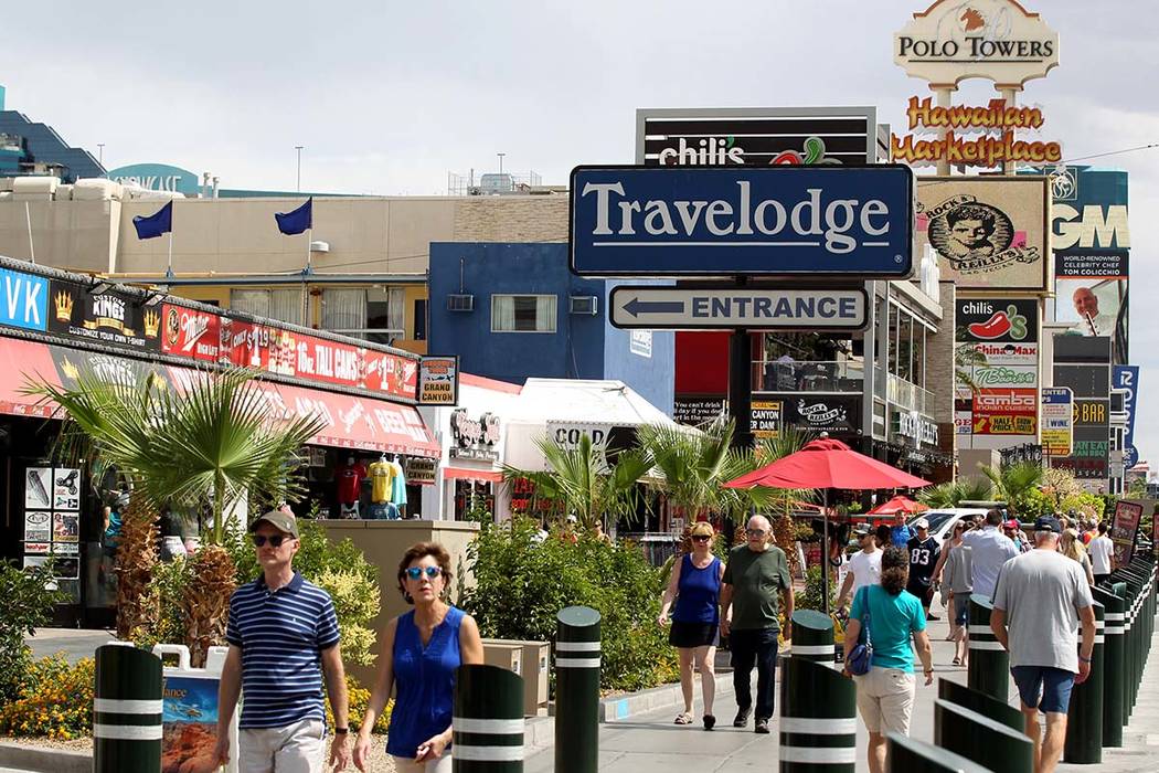 People walk on the Strip near Harmon Avenue past a 16-acre piece of property that includes the Hawaiian Marketplace that is for sale Tuesday, May 22, 2018. K.M. Cannon Las Vegas Review-Journal @KM ...
