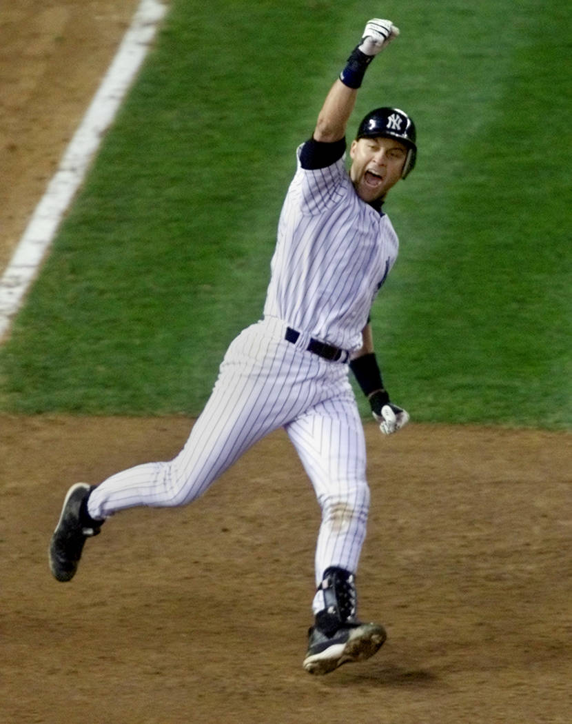 New York Yankees' Derek Jeter celebrates his game-winning home run in the 10th inning as he rounds first base against the Arizona Diamondbacks in Game 4 of the World Series, Wednesday, Oct. 31, 20 ...