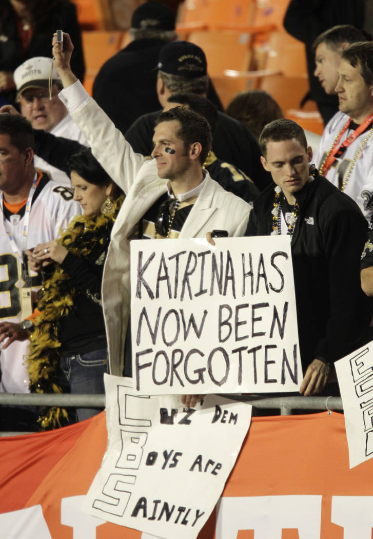 Fans hold a sign that reads "Katrina has now been forgotten", after the NFL Super Bowl XLIV football game between the Indianapolis Colts and New Orleans Saints in Miami, Sunday, Feb. 7, ...