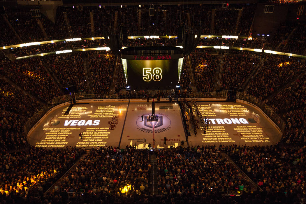 Names of the 58 people killed in the Route 91 Harvest Festival shooting are displayed on the hockey ring before the start of an NHL hockey game between the Vegas Golden Knights and the Arizona Coy ...