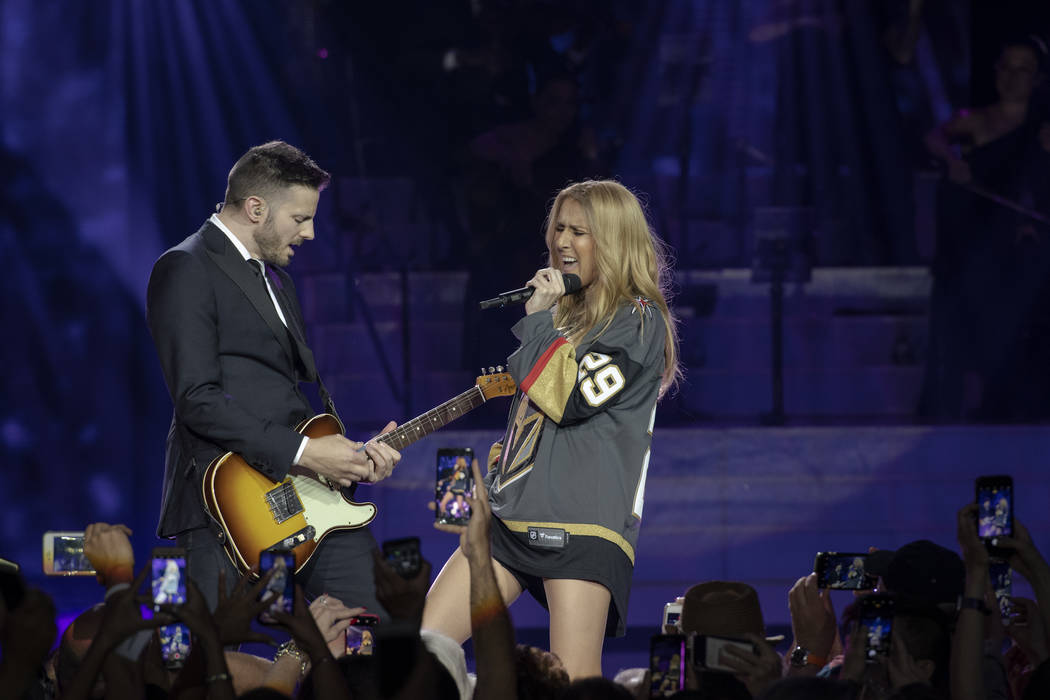 Celine Dion, shown with guitarist Kaven Girouard, sports a Marc-Andre Fleury Vegas Golden Knights jersey during her return to the Colosseum at Caesars Palace after minor ear surgery on Tuesday, Ma ...