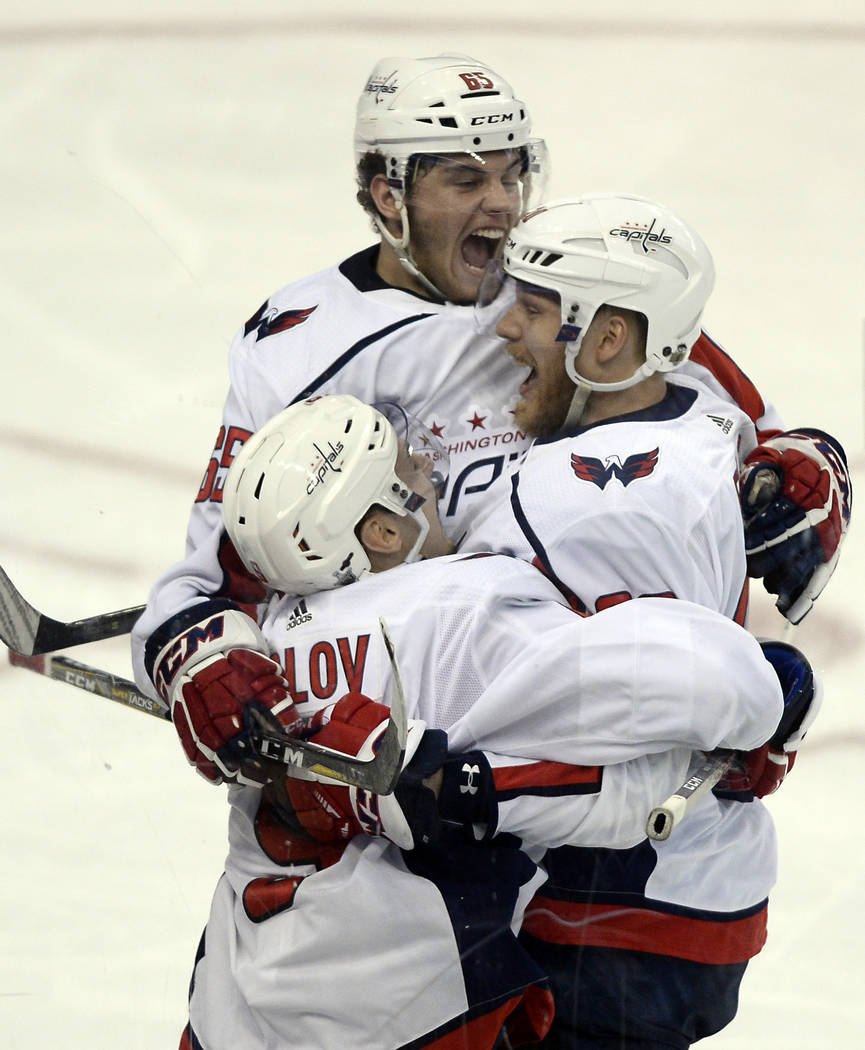 Washington Capitals left wing Andre Burakovsky, center, celebrates his goal against the Tampa Bay Lightning with Dmitry Orlov, left, and Lars Eller during the second period of Game 7 of the NHL Ea ...
