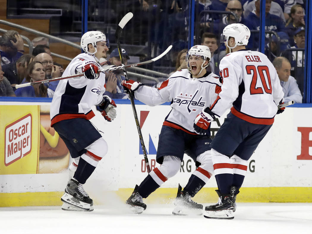Washington Capitals left wing Andre Burakovsky, center, celebrates his goal against the Tampa Bay Lightning with Washington Capitals' Dmitry Orlov, left, and Lars Eller (20) during the second peri ...
