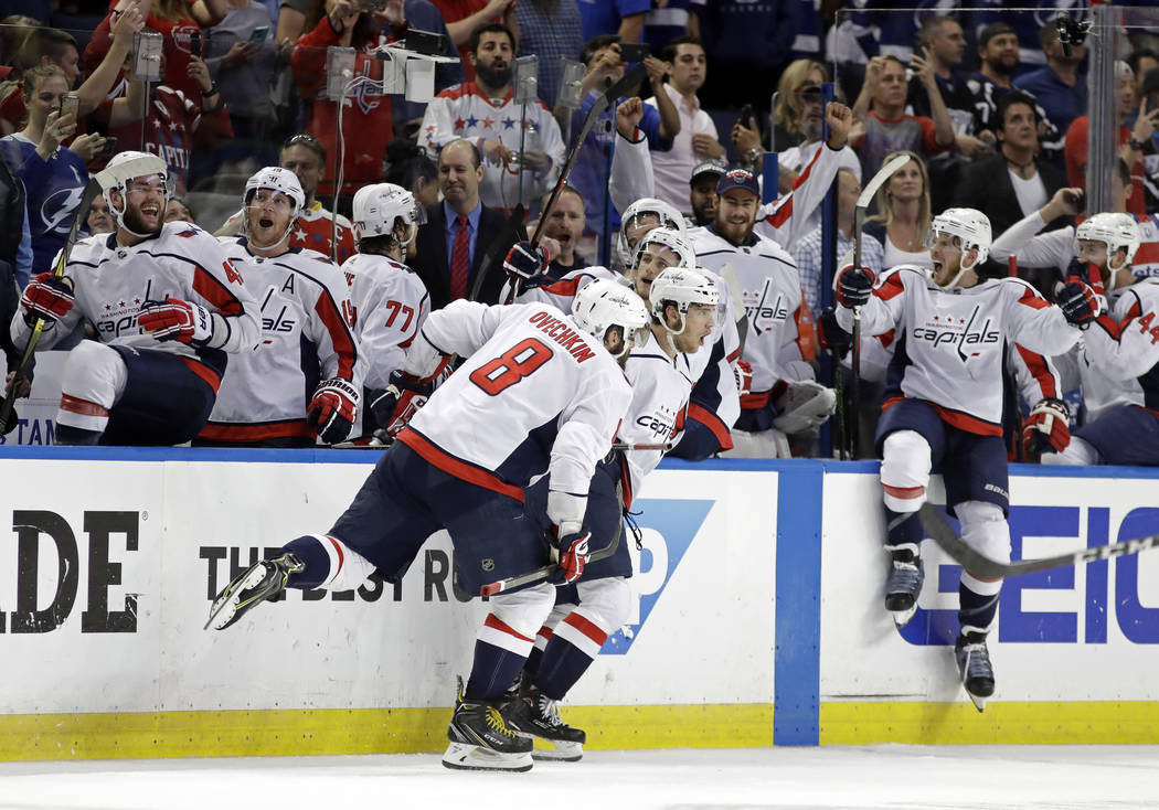 Washington Capitals, including left wing Alex Ovechkin (8). celebrate after defeating the Tampa Bay Lightning in Game 7 of the NHL Eastern Conference finals hockey playoff series Wednesday, May 23 ...