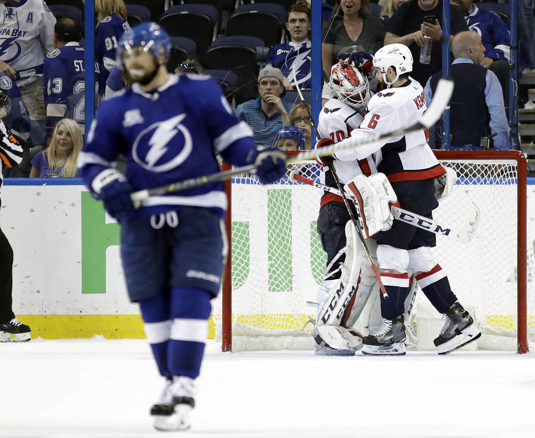 Washington Capitals defenseman Michal Kempny and goaltender Braden Holtby (70) celebrate after the Capitals defeated the Tampa Bay Lightning 4-0 in Game 7 of the NHL Eastern Conference finals hock ...