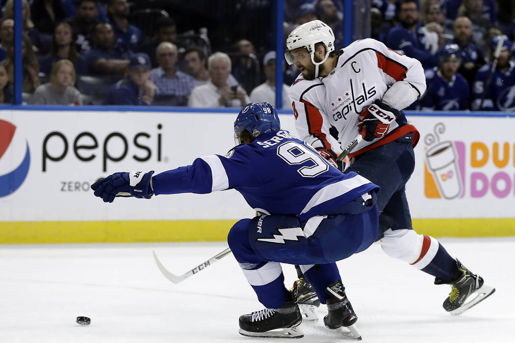 Washington Capitals left wing Alex Ovechkin, right, moves the puck past Tampa Bay Lightning defenseman Mikhail Sergachev during the first period of Game 7 of the NHL Eastern Conference finals hock ...