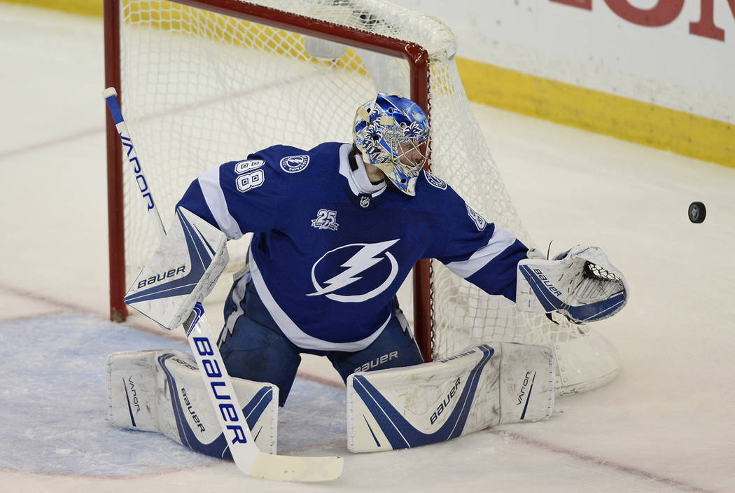 Tampa Bay Lightning goaltender Andrei Vasilevskiy deflects a Washington Capitals shot during the first period of Game 7 of the NHL Eastern Conference finals hockey playoff series Wednesday, May 23 ...