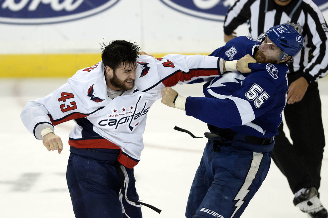 Tampa Bay Lightning defenseman Braydon Coburn (55) and Washington Capitals right wing Tom Wilson (43) fight during the first period of Game 7 of the NHL Eastern Conference finals hockey playoff se ...