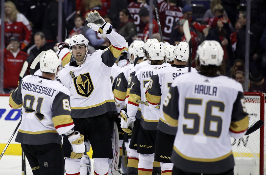 Vegas Golden Knights right wing Alex Tuch, left, center, and others celebrate after an NHL hockey game against the Washington Capitals, Sunday, Feb. 4, 2018, in Washington. (AP Photo/Alex Brandon)