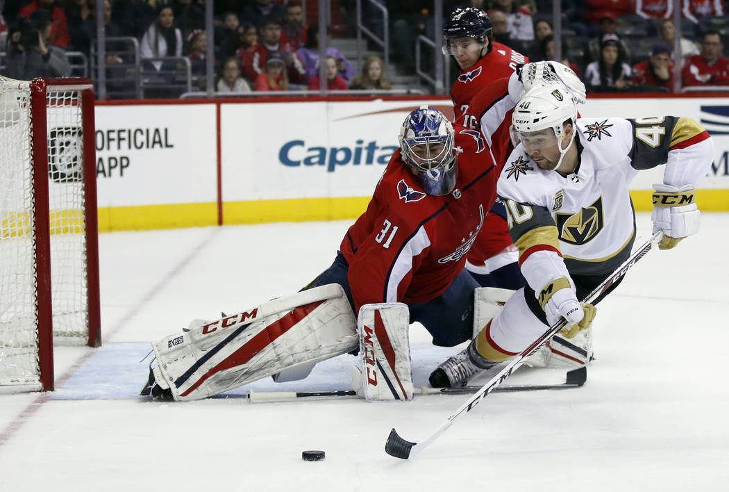 Vegas Golden Knights center Ryan Carpenter (40) lunges to shoot the puck as Washington Capitals goaltender Philipp Grubauer (31), from Germany, defends in the first period of an NHL hockey game, S ...