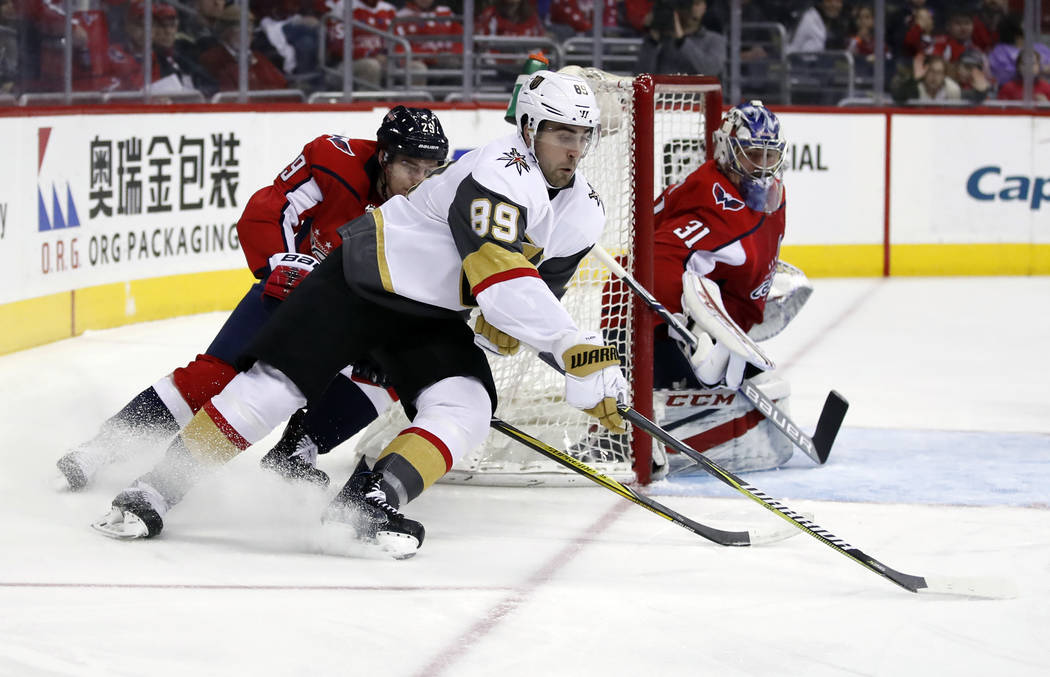 Vegas Golden Knights right wing Alex Tuch (89) skates with the puck as Washington Capitals defenseman Christian Djoos (29), from Sweden, and goaltender Philipp Grubauer (31), watch during the firs ...