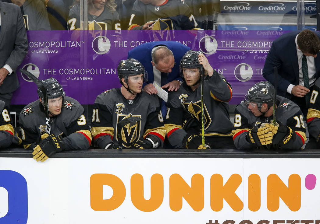 Golden Knights coach Gerard Gallant, center, talks with Jonathan Marchessault (81) and William Karlsson (71) during the second period of Game 1 of an NHL hockey first-round playoff series between ...