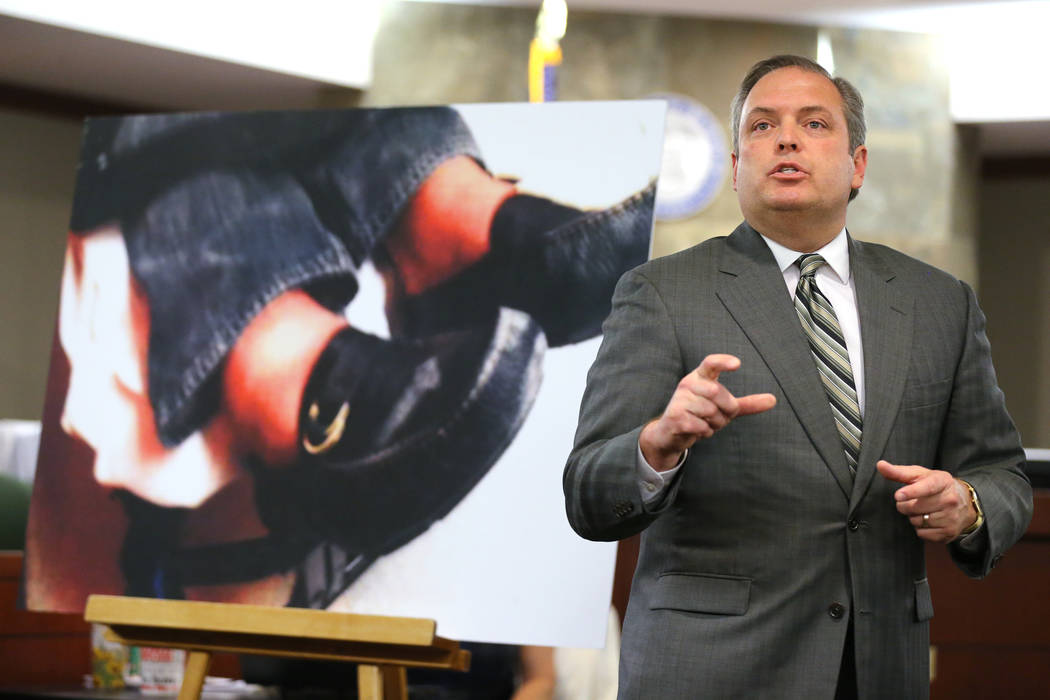 MGM attorney Jerry Popovich shows a photo of the plaintiff's feet during closing arguments at the Regional Justice Center in Las Vegas Thursday, May 24, 2018, in the civil trial involving magician ...