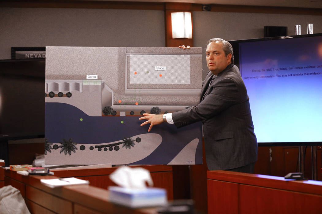 MGM attorney Jerry Popovich shows a photo of the path the plaintiff took during closing arguments at the Regional Justice Center in Las Vegas Thursday, May 24, 2018, in the civil trial involving m ...