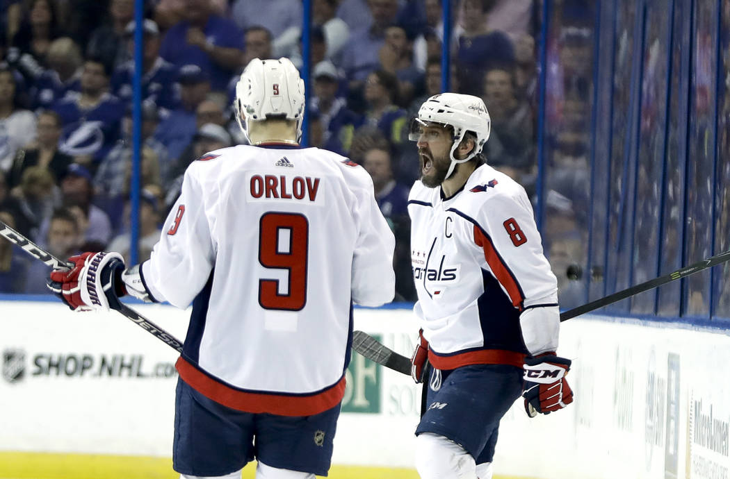 Washington Capitals left wing Alex Ovechkin (8) celebrates his goal against the Tampa Bay Lightning with teammate defenseman Dmitry Orlov (9) during the first period of Game 7 of the NHL Eastern C ...