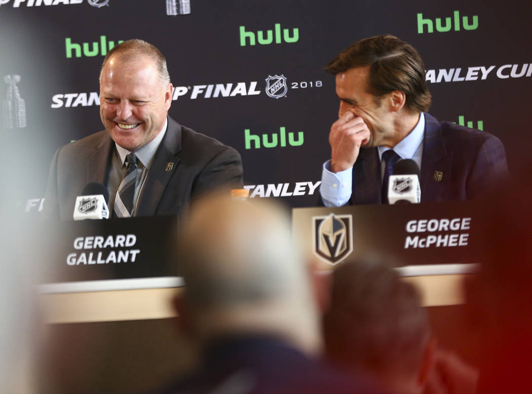Golden Knights head coach Gerard Gallant, left, and George McPhee, general manager of the team, share a laugh during NHL hockey media day for the Stanley Cup Final at the T-Mobile Arena in Las Veg ...