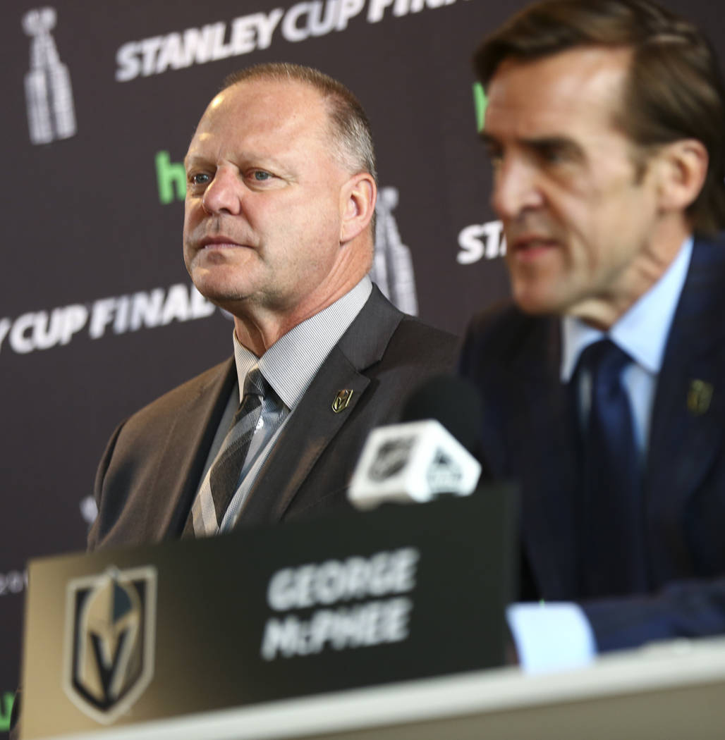Golden Knights head coach Gerard Gallant looks on as George McPhee, general manager of the team, speaks during NHL hockey media day for the Stanley Cup Final at the T-Mobile Arena in Las Vegas on ...