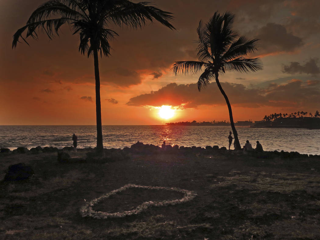 The sun sets through “vog,” or volcanic smog, in Kailua-Kona, Hawaii. (Chris Stewart via AP)