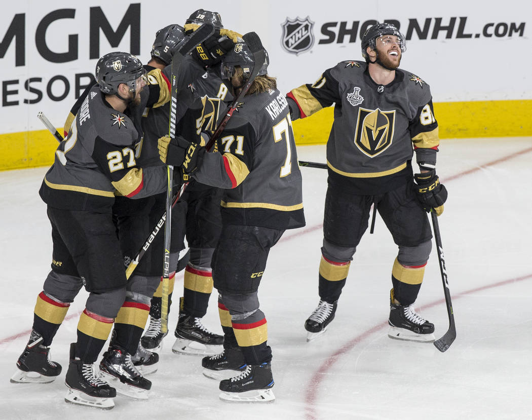 Golden Knights right wing Reilly Smith (19) celebrates with teammates Jonathan Marchessault (81), Deryk Engelland (5), Shea Theodore (27) and William Karlsson (71) after scoring a second-period go ...