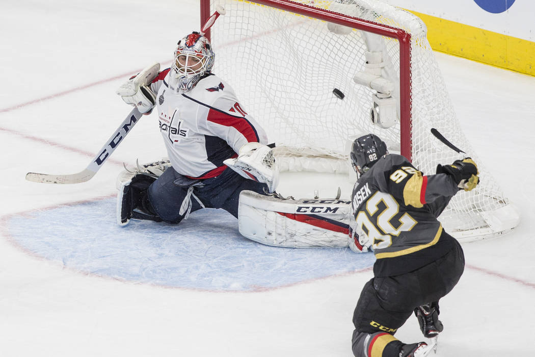 Golden Knights center Tomas Nosek (92) scores a third-period goal against Capitals goaltender Braden Holtby (70) during Game 1 of the NHL Stanley Cup Finals on Monday, May 28, 2018, at T-Mobile Ar ...