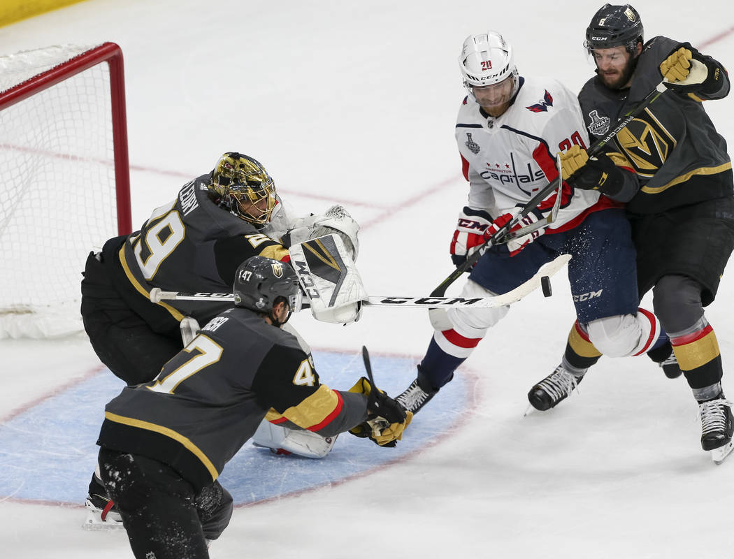 Vegas Golden Knights goaltender Marc-Andre Fleury (29) deflects the puck as Washington Capitals center Lars Eller (20) looks for the rebounds during the third period in Game 1 of the NHL hockey St ...