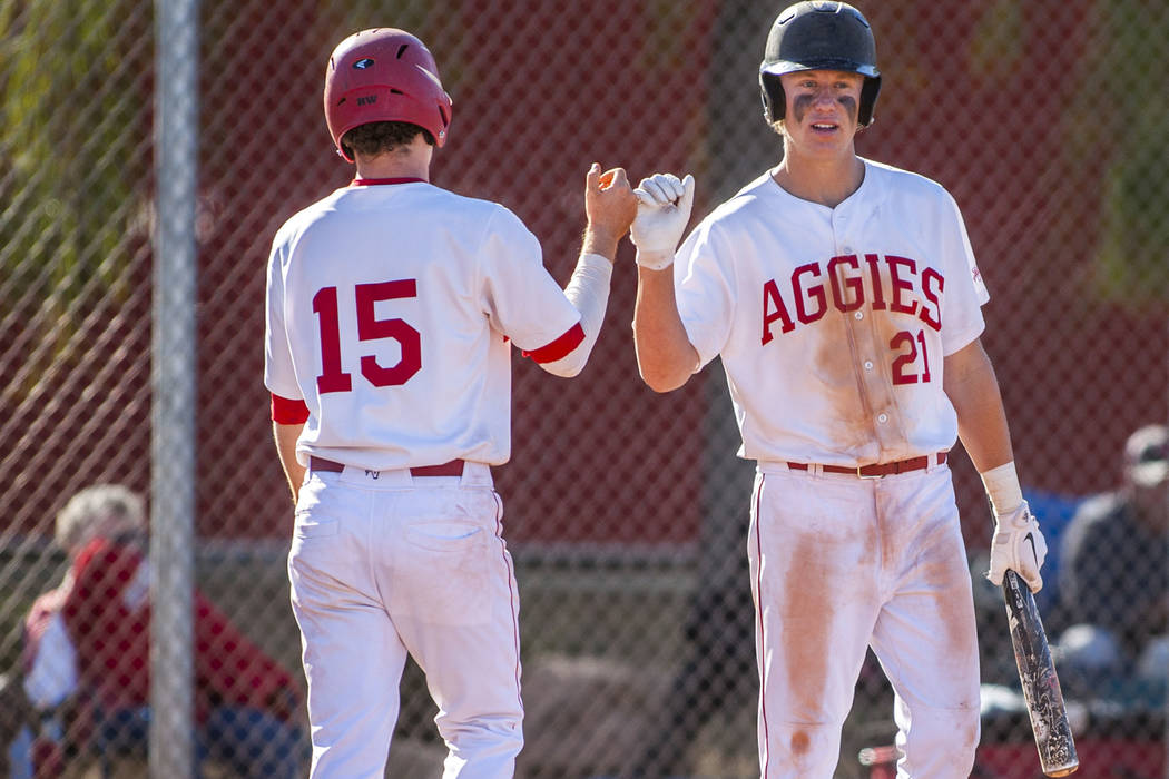 Arbor View pitcher and infielder Austin Pfeifer (21) celebrates with infielder Bradley Stone after Pfeifer hit a home run during the fifth inning at Arbor View High School in Las Vegas on Tuesday, ...