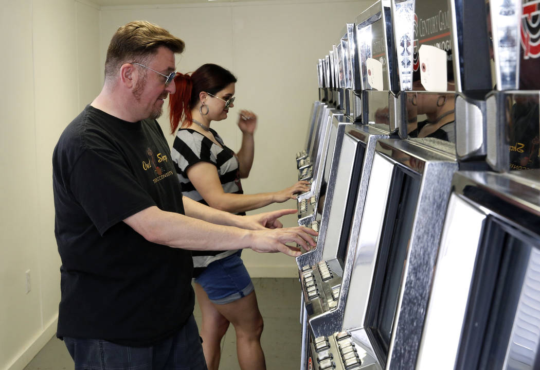 Andy Martello of Las Vegas and Liz Vestal of Nashville, Tenn., play a slot machine inside a trailer on the Moulin Rouge site on Tuesday, May 29, 2018, in Las Vegas. Representatives of the trust th ...