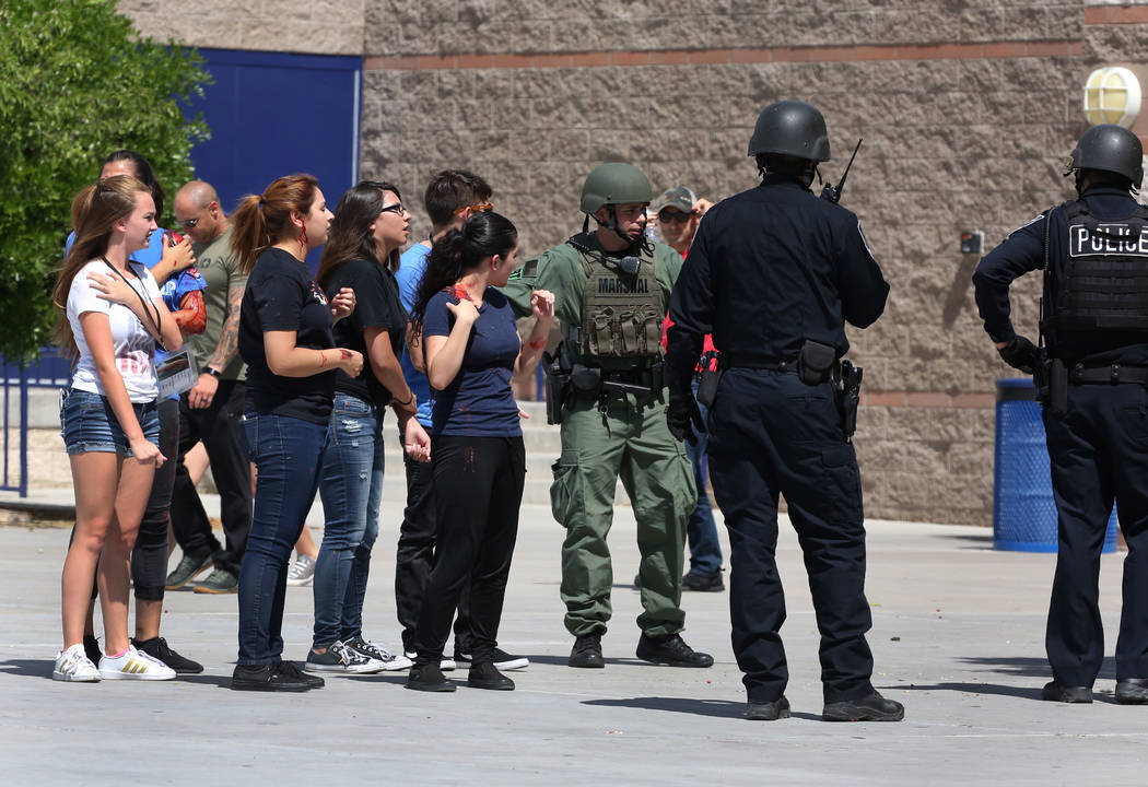 Las Vegas police officers conduct a mass shooting drill with students, coordinated by the Metropolitan Police Department and the various agencies in the area, at Shadow Ridge High School on Wednes ...