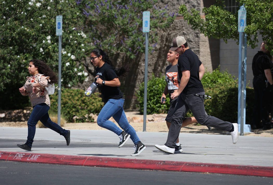 Shadow Ridge High School students run out of their school during a mass shooting drill, coordinated by the Metropolitan Police Department and the various agencies in the area, on Wednesday, May 30 ...