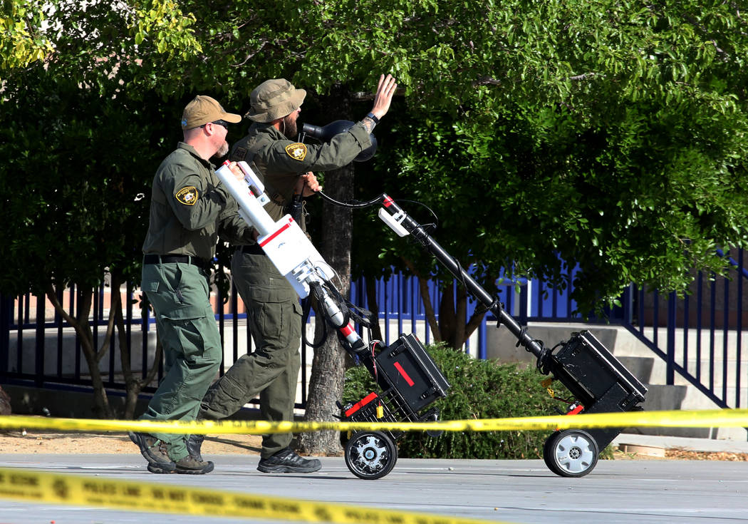 Las Vegas police officers bring camera and communication equipment during a mass shooting drill, coordinated by the Metropolitan Police Department and the various agencies in the area, at Shadow R ...