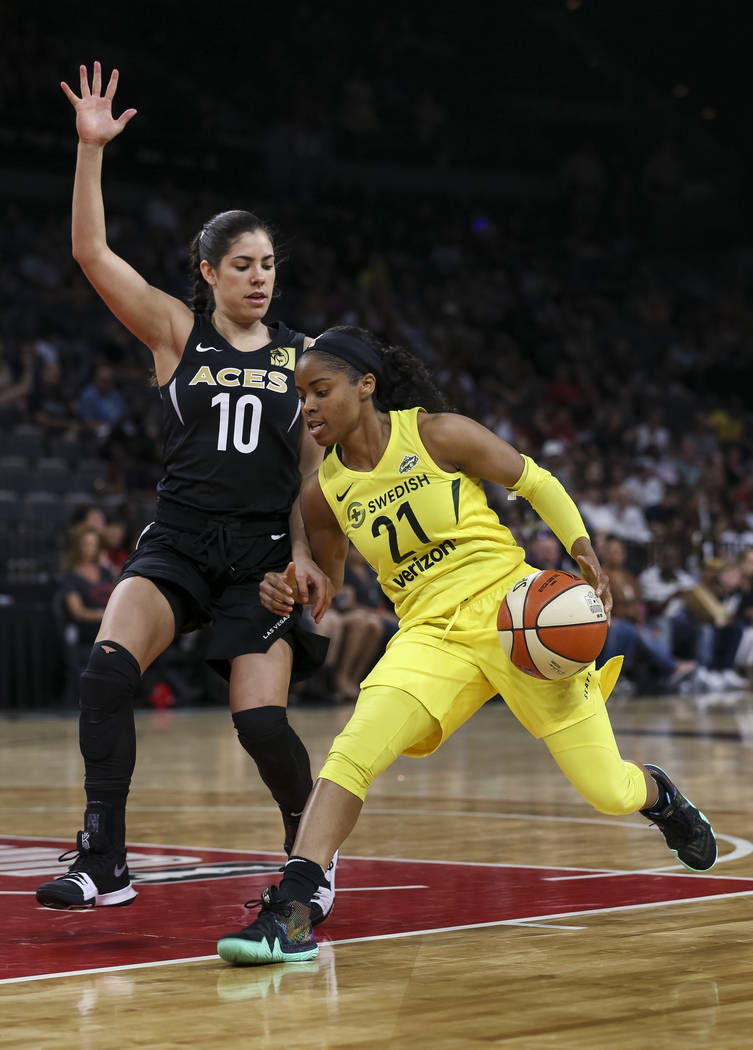 Seattle Storm guard Jordin Canada (21) drives the ball against Las Vegas Aces guard Kelsey Plum (10) in the first half of a WNBA basketball game at the Mandalay Bay Events Center in Las Vegas on S ...