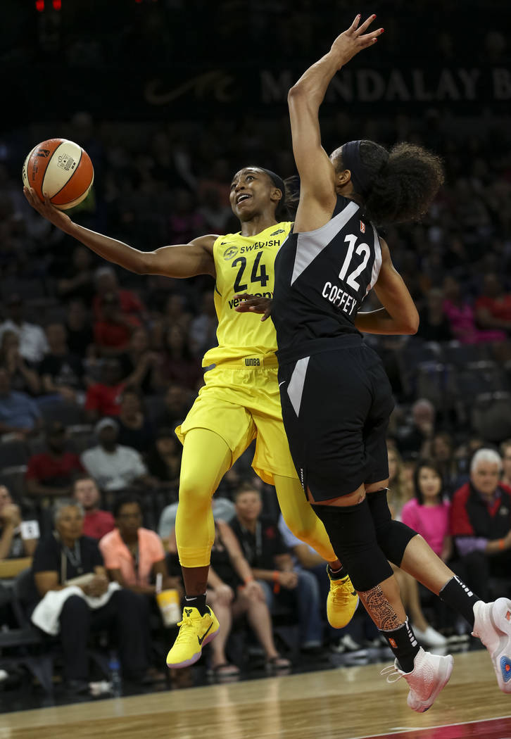Seattle Storm guard Jewell Loyd (24) goes up for a shot against Las Vegas Aces forward Nia Coffey (12) in the first half of a WNBA basketball game at the Mandalay Bay Events Center in Las Vegas on ...