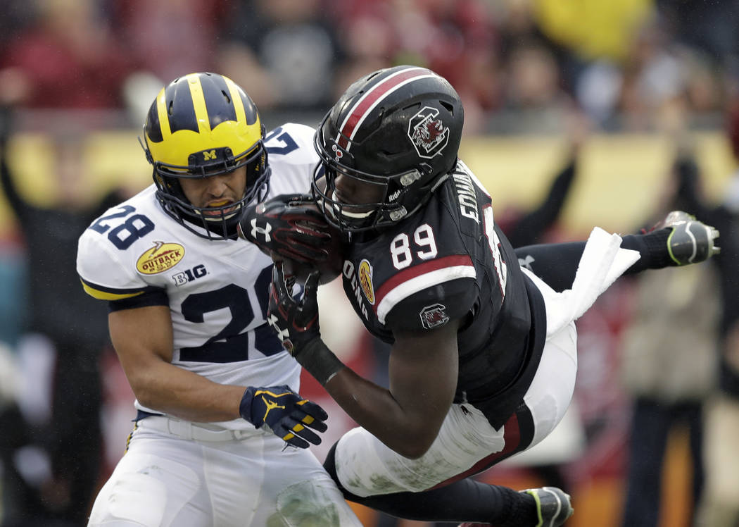 South Carolina wide receiver Bryan Edwards (89) pulls in a 21-yard touchdown reception in front of Michigan defensive back Brandon Watson (28) during the second half of the Outback Bowl NCAA colle ...