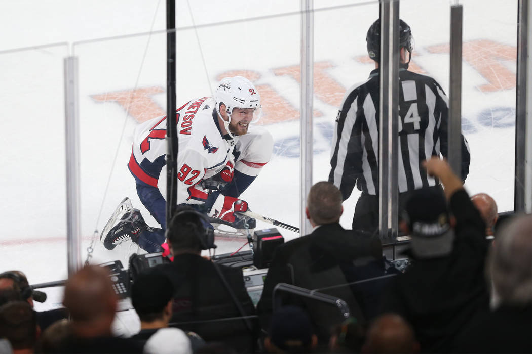 Washington Capitals center Evgeny Kuznetsov (92)reacts after taking a hit against the Vegas Golden Knights during the first period in Game 2 of the NHL hockey Stanley Cup Final at T-Mobile Arena i ...