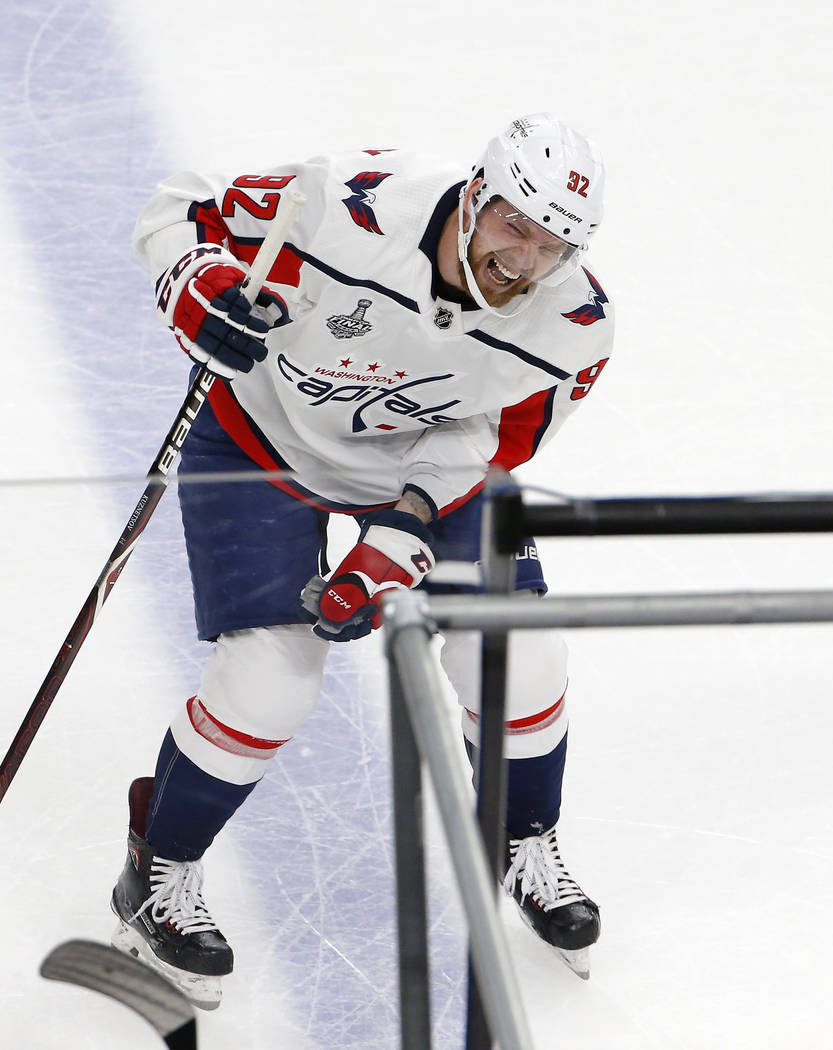 Washington Capitals center Evgeny Kuznetsov, of Russia, winces after a check by Vegas Golden Knights defenseman Brayden McNabb during the first period in Game 2 of the NHL hockey Stanley Cup on Fi ...
