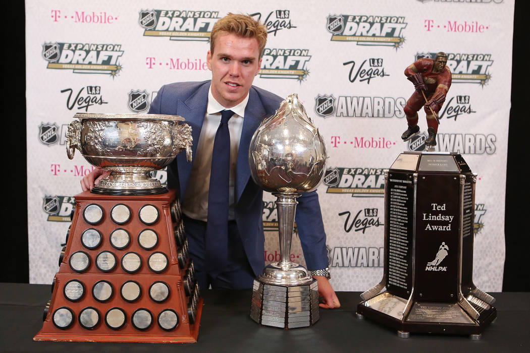 Connor McDavid of the Edmonton Oilers is pictured with the Art Ross Trophy, left, Hart Memorial Trophy, center, and Ted Lindsay Award, right, all of which were awarded to him at the 2017 NHL Award ...