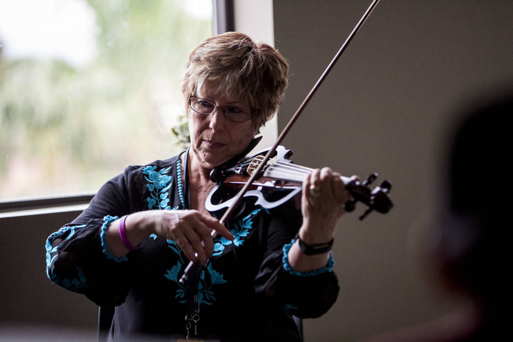 Music therapist Judith Pinkerton plays the violin in a session working with recovering addicts at the Resolutions Recovery center in Las Vegas on Tuesday, April 26, 2018. Patrick Connolly Las Veg ...