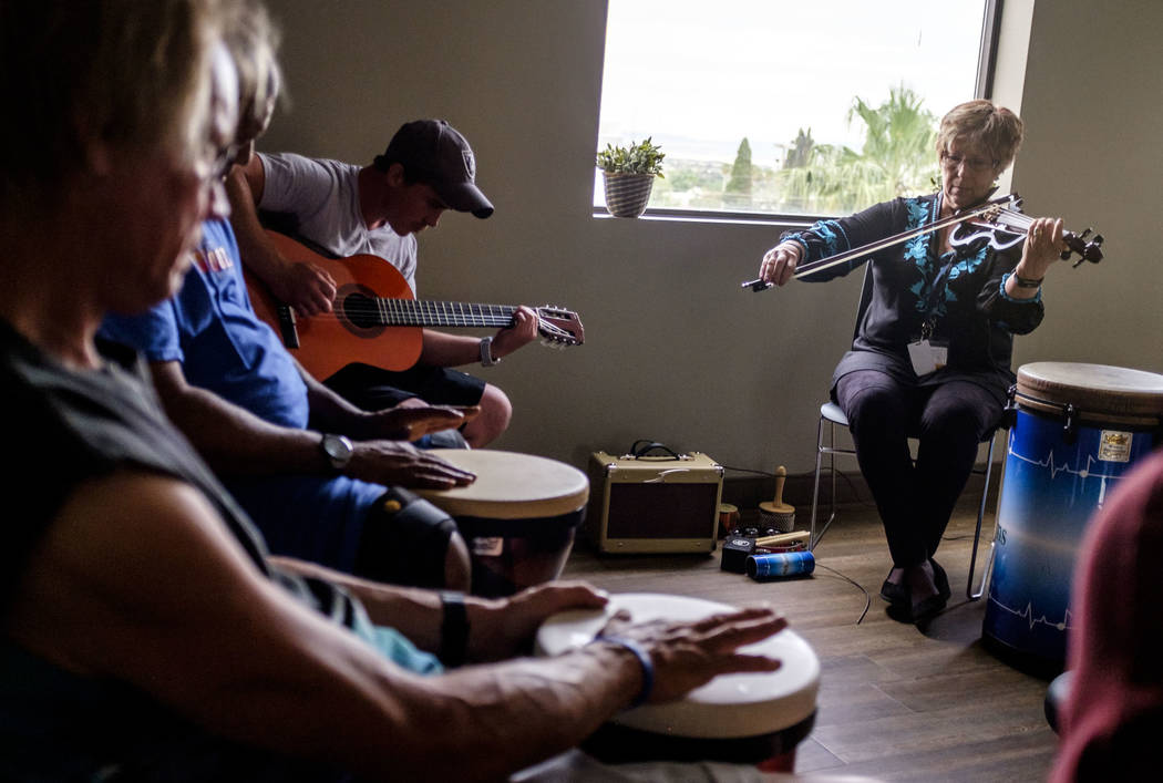 Music therapist Judith Pinkerton plays the violin while Shawn Wallen plays guitar in a session working with recovering addicts at the Resolutions Recovery center in Las Vegas on Tuesday, April 26, ...