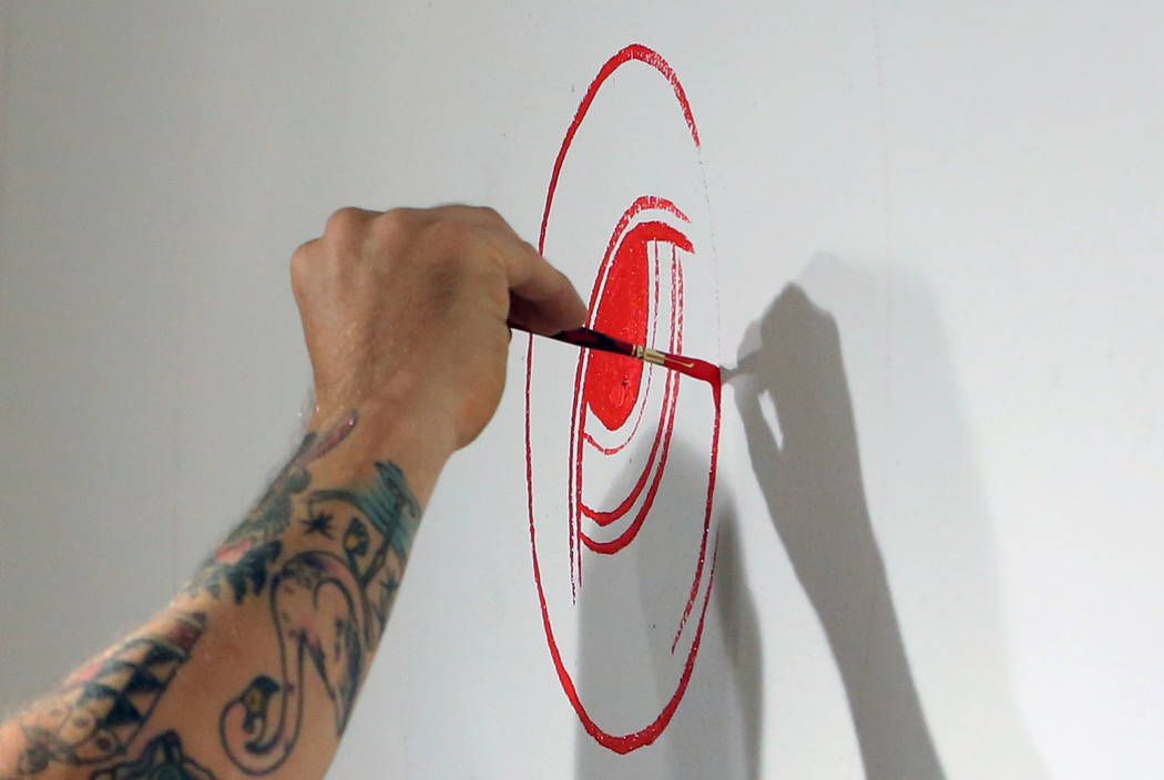 Los Angeles-based artist, Andrew Schoultz, paints on the wall on Friday, May 25, 2018, as he prepares for his upcoming exhibit at the UNLV Marjorie Barrick Museum of Art in Las Vegas. Bizuayehu Te ...